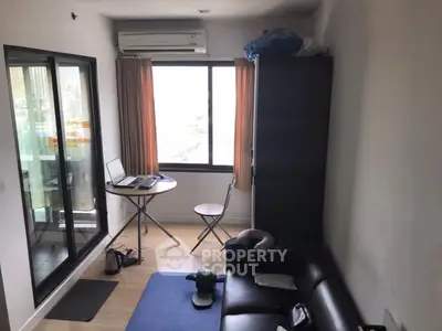 Compact living room with balcony access and air conditioning