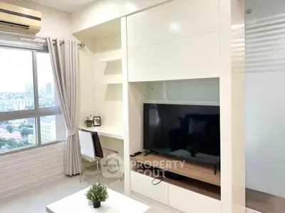 Modern living room with large window and TV, featuring sleek furniture and city view.