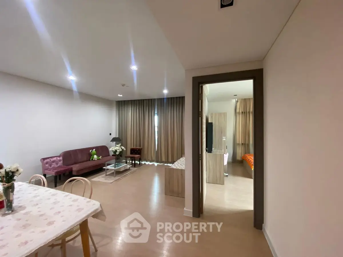 Spacious open-plan living room with modern decor and natural light