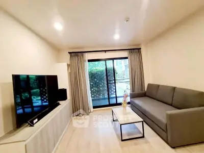 Modern living room with sleek furniture and large TV, opening to a cozy balcony with garden view.