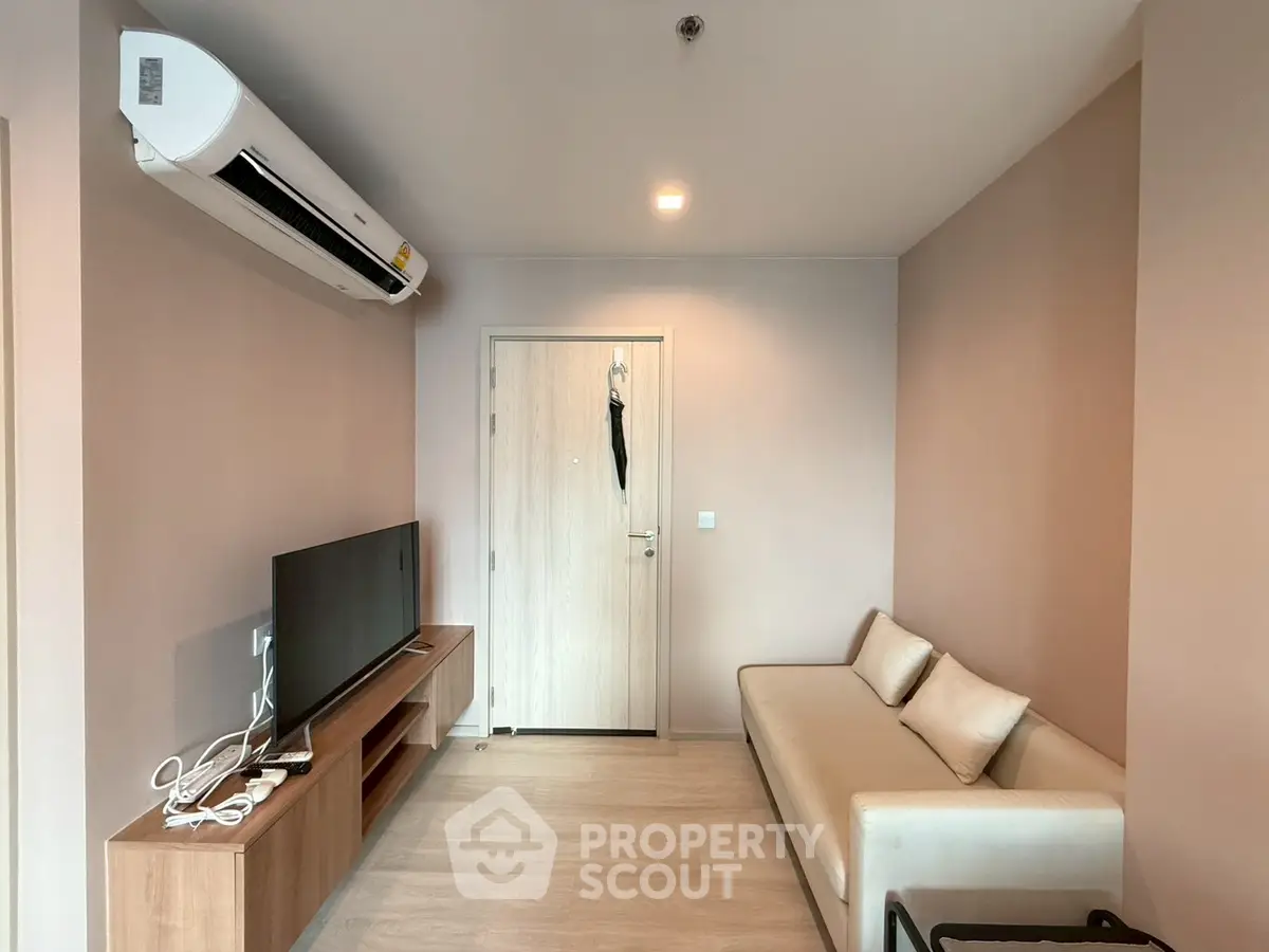 Modern living room with sleek furniture and wall-mounted TV