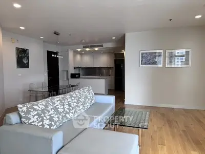 Spacious modern living room with open kitchen and stylish decor in a contemporary apartment.