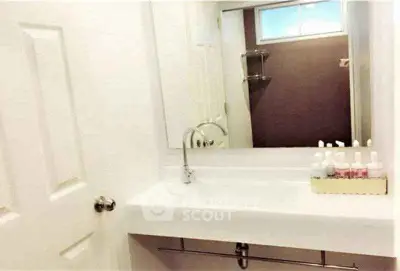 Modern bathroom with sleek sink and large mirror, ideal for contemporary living.