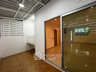 Modern interior with sliding glass doors and tiled flooring in a spacious living area.
