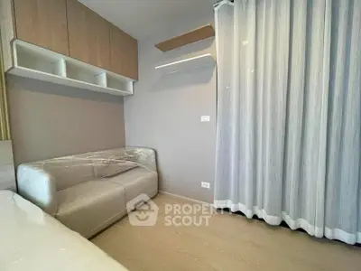 Modern bedroom with sleek storage and cozy sofa in a stylish apartment