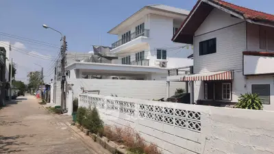 Charming residential street with modern and traditional homes, showcasing diverse architectural styles.