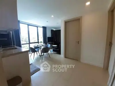 Modern open-plan living room with dining area and large windows