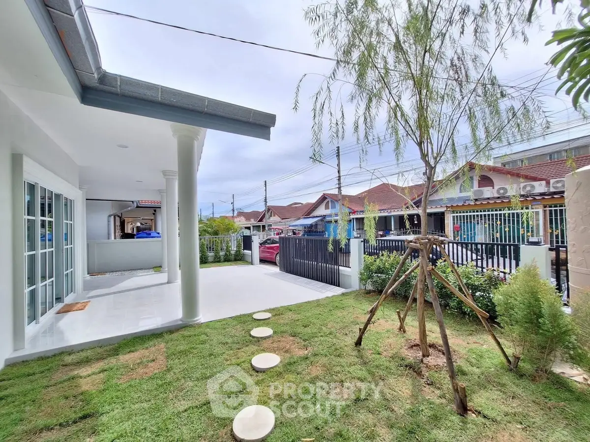 Charming suburban home with lush garden and spacious patio, perfect for outdoor relaxation.