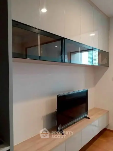 Modern living room with sleek TV unit and glossy cabinets