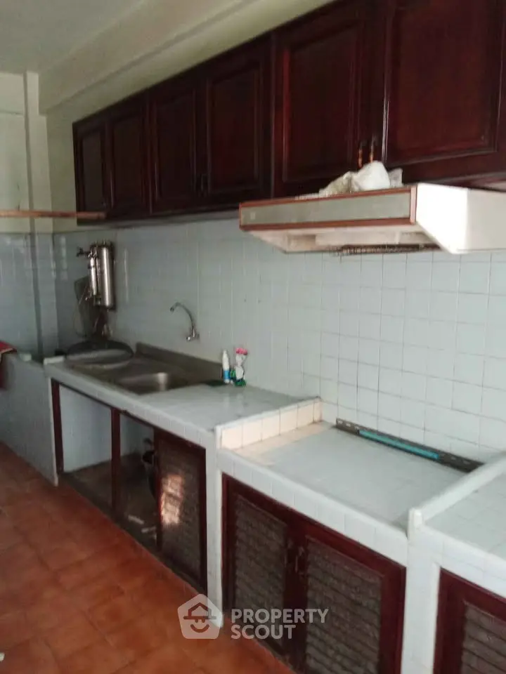 Charming kitchen with classic wooden cabinets and tiled backsplash