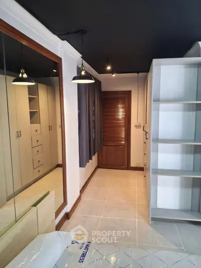 Spacious bedroom with modern closet and elegant lighting