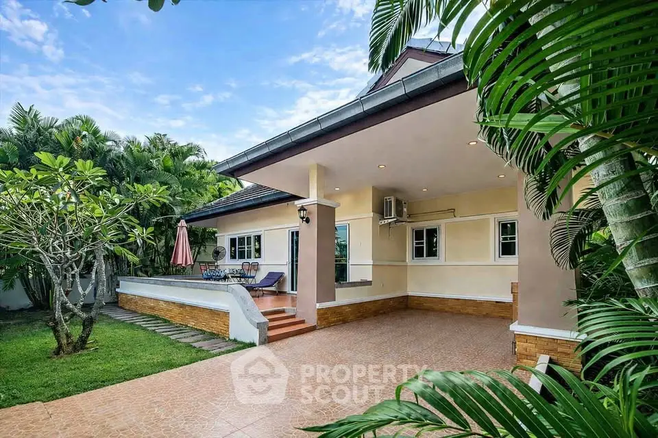 Charming single-story home with lush garden and spacious patio, perfect for outdoor entertaining.