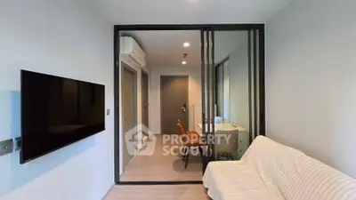 Modern living room with sleek glass partition and cozy seating area