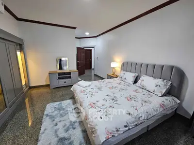 Spacious bedroom with elegant decor and modern furnishings