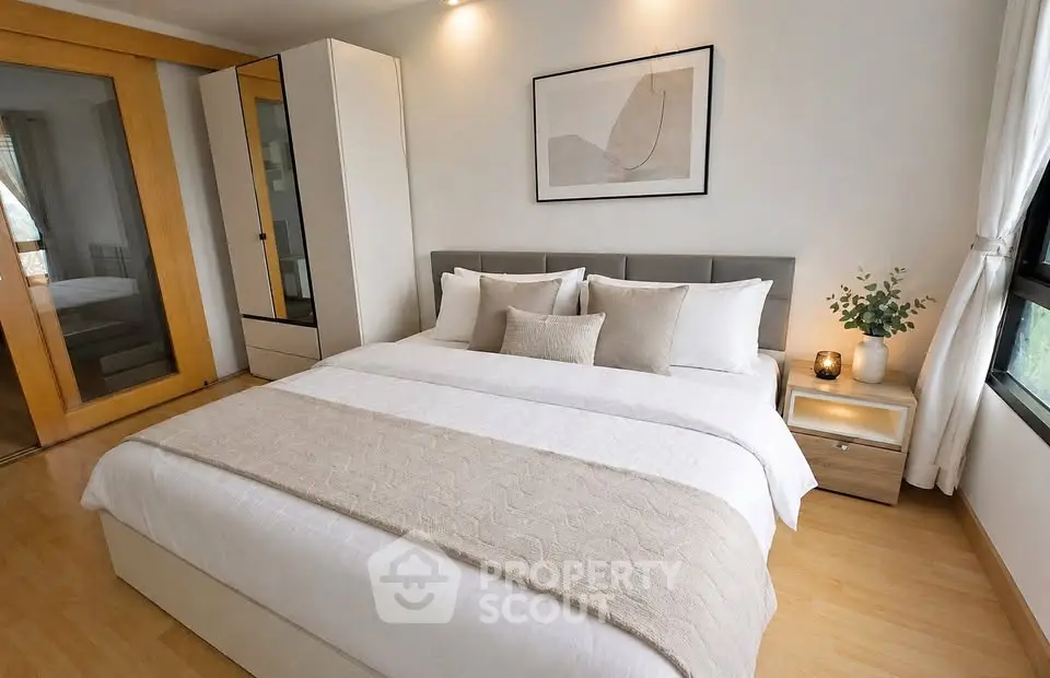Elegant bedroom with modern decor and cozy ambiance, featuring a large bed and stylish furnishings.