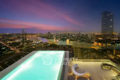 Stunning rooftop pool with breathtaking city skyline view at sunset, perfect for luxury urban living.