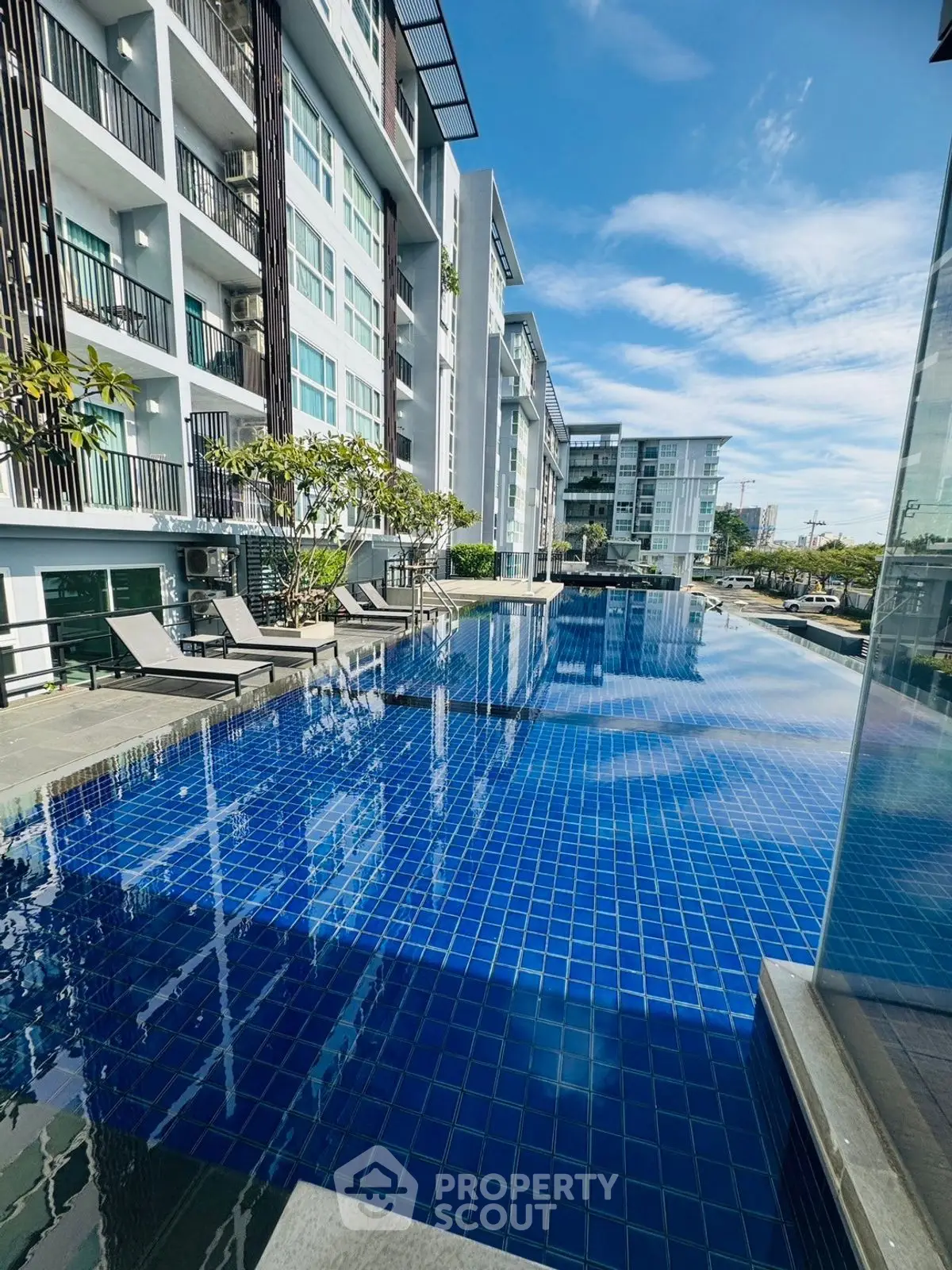 Luxurious condominium with stunning blue pool and modern architecture