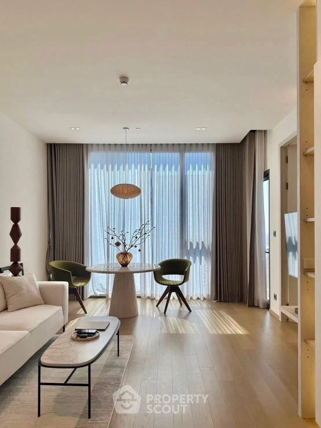 Modern living room with elegant decor and large windows for natural light