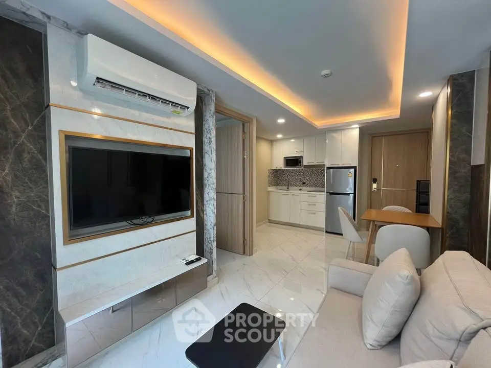 Modern living room with sleek kitchen, marble flooring, and ambient lighting in a stylish apartment.