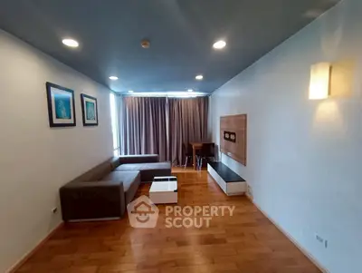 Spacious modern living room with wooden flooring and stylish furniture