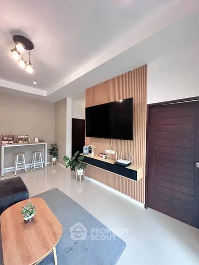 Modern living room with wall-mounted TV and stylish decor
