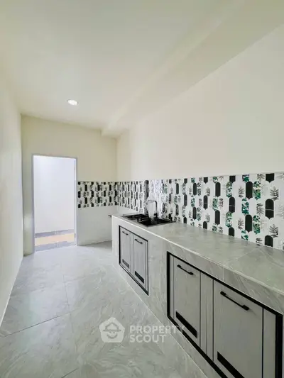 Modern kitchen with sleek design and stylish backsplash