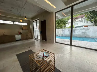 Spacious modern living room with pool view and minimalist decor