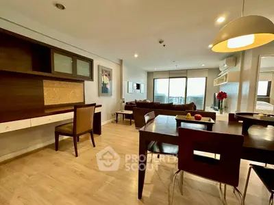 Spacious open-plan living and dining area with modern furnishings and natural light.