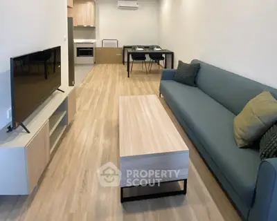 Modern living room with sleek furniture and open kitchen layout