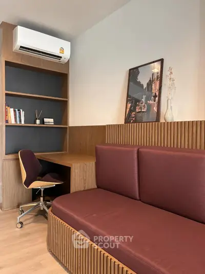 Modern study room with built-in wooden desk, cozy chair, and air conditioning, perfect for productivity.