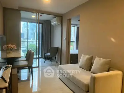 Modern living room with city view, elegant furniture, and natural light.