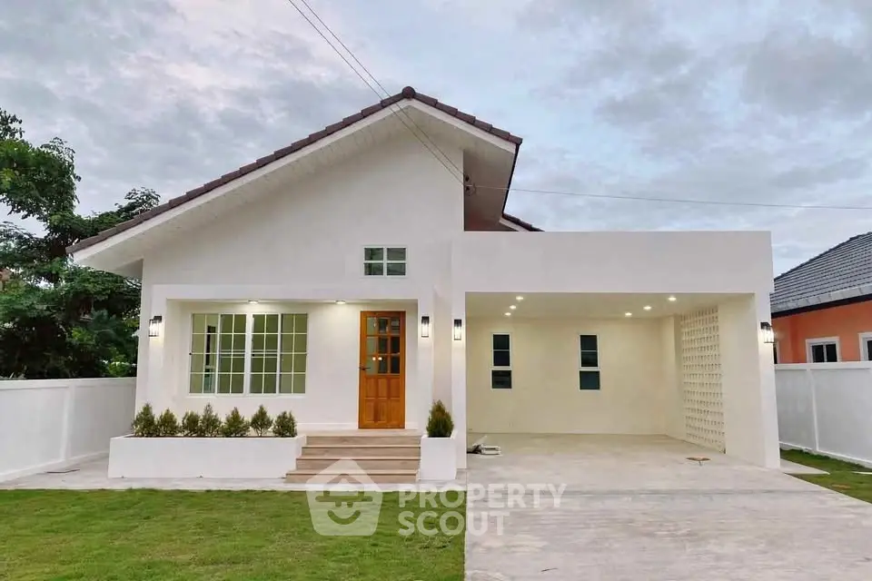 Charming modern house with spacious driveway and lush green lawn, perfect for family living.