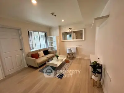 Modern living room with cozy sofa and stylish decor in a bright apartment.