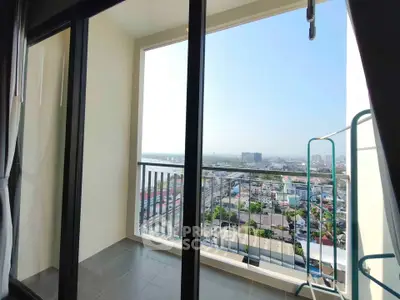 Spacious balcony with stunning city view in modern high-rise apartment.