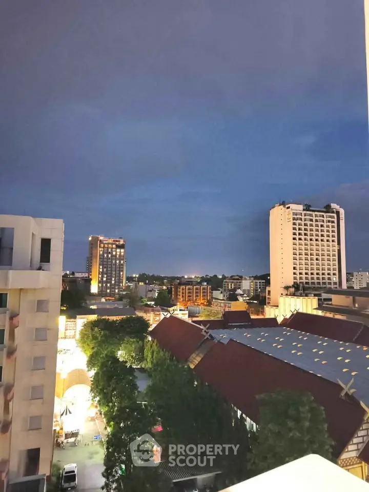 Stunning cityscape view from a high-rise balcony at dusk, showcasing urban architecture and vibrant skyline.