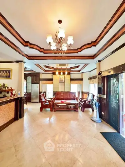 Elegant living room with classic wooden furniture and intricate ceiling design.