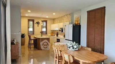 Spacious kitchen with modern appliances and dining area in elegant home