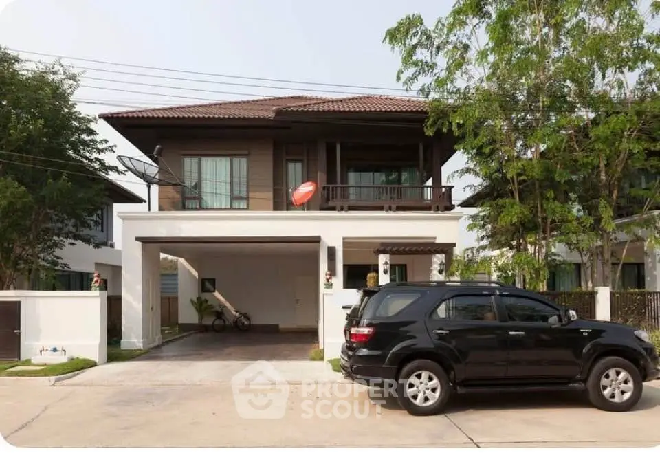 Charming two-story house with spacious driveway and lush greenery, perfect for family living.