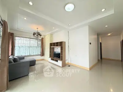 Spacious living room with modern decor and large windows for natural light