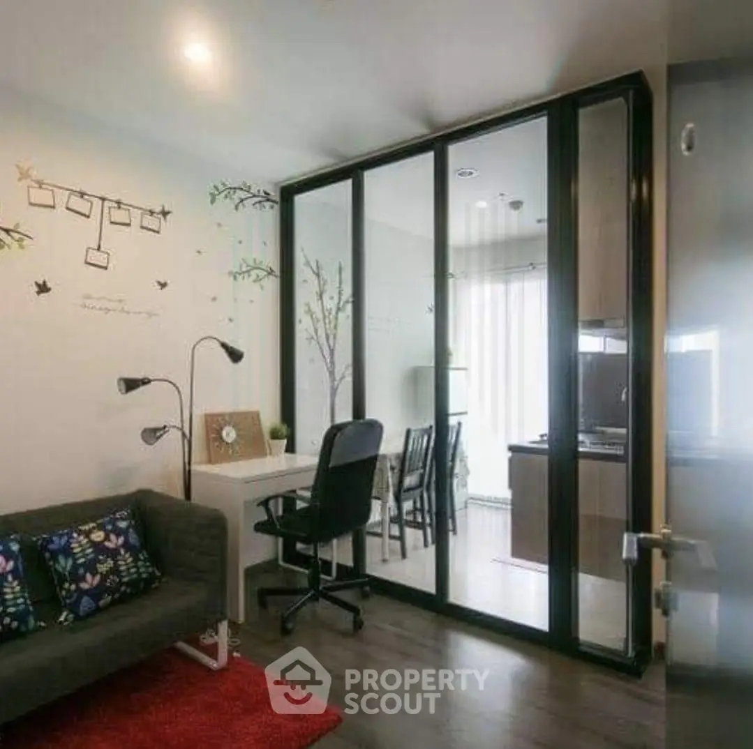Modern living room with glass partition and stylish decor