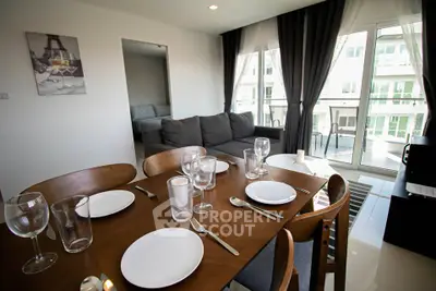 Modern living room with dining area and balcony view in stylish apartment