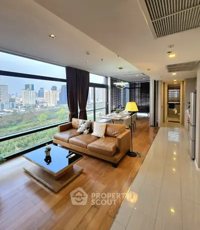 Luxurious living room with stunning city view and modern furnishings in high-rise apartment.