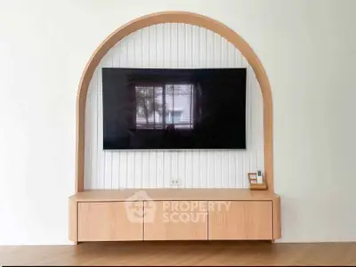 Modern living room with stylish TV unit and wooden arch design