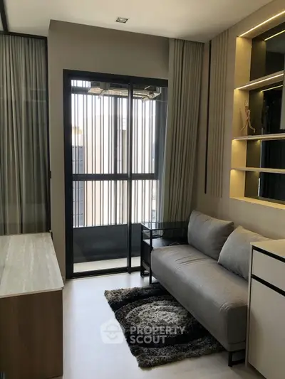 Modern living room with sleek furniture and large window for natural light