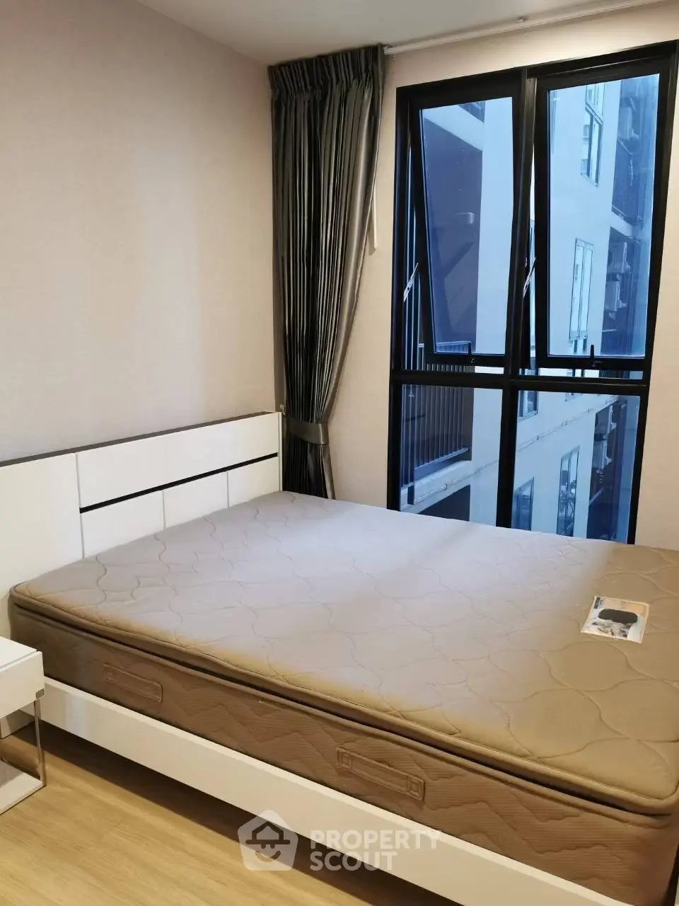 Modern bedroom with large window and stylish decor in urban apartment