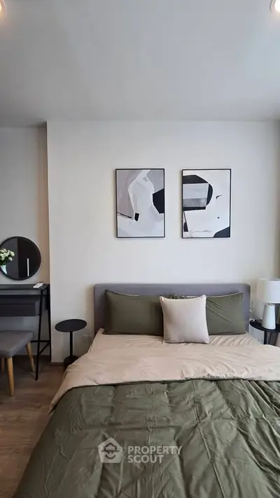 Modern bedroom with stylish decor and cozy bedding in a contemporary apartment.
