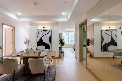 Modern dining area with elegant decor and large mirror reflecting a stylish living space.