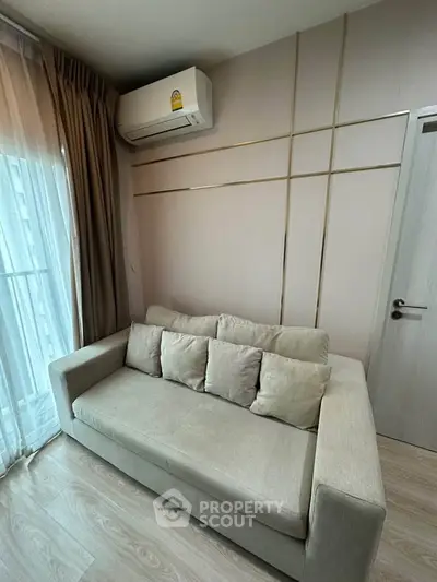 Modern living room with stylish sofa and air conditioning, perfect for urban living.