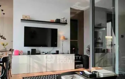 Modern living room with sleek furniture and large TV, perfect for stylish urban living.