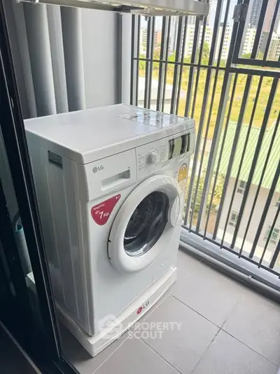 Modern washing machine on a balcony with city view, perfect for urban living convenience.